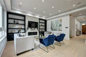 Professionally staged tv room with modern artwork and blue and white décor