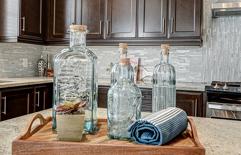 Vignette with glass bottles, decorative towel and rustic accents